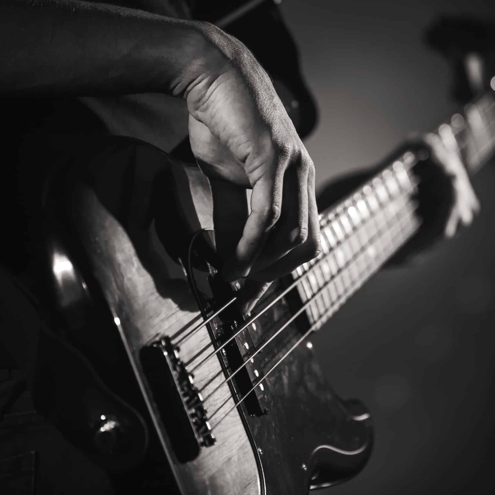 Electric bass guitar player hands, live music